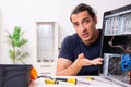 Young man repairing computer at home Royalty Free Stock Photo