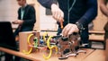 Young man repairing DIY robot