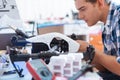 Young man repairing drone and using different equipment Royalty Free Stock Photo