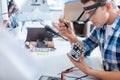 Young man repairing drones chip with a screwdriver Royalty Free Stock Photo