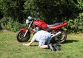 Young man repairing a motorbike Royalty Free Stock Photo