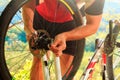 Young man repairing mountain bike in the forest Royalty Free Stock Photo