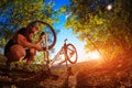 Young man repairing mountain bike in the forest Royalty Free Stock Photo