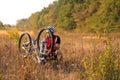 Young man repairing mountain bike in the forest Royalty Free Stock Photo