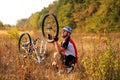 Young man repairing mountain bike in the forest Royalty Free Stock Photo