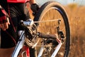 Young man repairing mountain bike in the forest Royalty Free Stock Photo