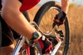 Young man repairing mountain bike in the forest Royalty Free Stock Photo