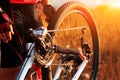 Young man repairing mountain bike in the forest Royalty Free Stock Photo