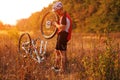 Young man repairing mountain bike in the forest Royalty Free Stock Photo