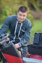 Young man repairing mower Royalty Free Stock Photo