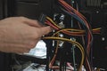 Young man repairs a computer system unit, changes parts, video card and hard drive, sets new components. Computer Repair