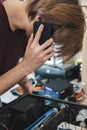 Young man repairs a computer system unit, changes parts, video card and hard drive, sets new components. Computer Repair Royalty Free Stock Photo