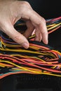 Young man repairs a computer system unit, changes parts, video card and hard drive, sets new components. Computer Repair Royalty Free Stock Photo