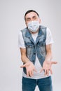 Young man in a respiratory mask looking at camera can`t understand what did wrong