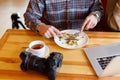 Young man resting and eating and drinking tea in the cafe. Royalty Free Stock Photo