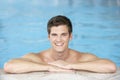 Young Man Resting On Edge Of Swimming Pool Royalty Free Stock Photo