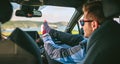 Young man resting feet up sitting on the car Royalty Free Stock Photo