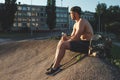 Young man resting after training, sportsman, outdoor training in the city copy space