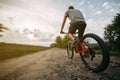 Young man riding bicycle along a country road Royalty Free Stock Photo