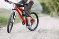 Young man riding bicycle along dusty country road Royalty Free Stock Photo