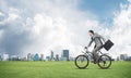 Young man riding bicycle on green grass