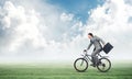 Young man riding bicycle on green grass