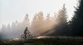 Young man riding bicycle in the mountains in early morning
