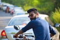 Young man riding bike and looking back Royalty Free Stock Photo