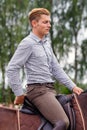 Young man riding brown horse on the countryside Royalty Free Stock Photo