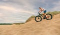 Man riding fast fat bike through beach dunes Royalty Free Stock Photo