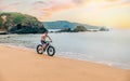 Young man riding a fat bike on the beach Royalty Free Stock Photo