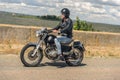 Young man riding his motorbike on open road Royalty Free Stock Photo