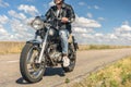 Young man riding his motorbike on open road Royalty Free Stock Photo