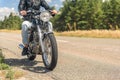 Young man riding his motorbike on open road Royalty Free Stock Photo