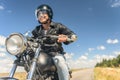 Young man riding his motorbike on open road Royalty Free Stock Photo