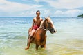 Young man riding horse on the beach on Taveuni Island, Fiji