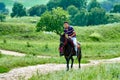 A young man riding horse on the meadow Royalty Free Stock Photo