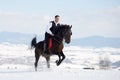 Young man riding horse outdoor in winter Royalty Free Stock Photo