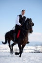 Young man riding horse outdoor in winter Royalty Free Stock Photo