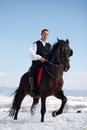 Young man riding horse outdoor in winter Royalty Free Stock Photo