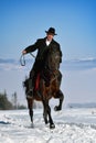 Young man riding horse outdoor in winter Royalty Free Stock Photo
