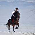 Young man riding horse outdoor in winter Royalty Free Stock Photo