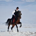 Young man riding horse outdoor in winter Royalty Free Stock Photo