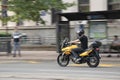 Young man riding a motorbike on city street