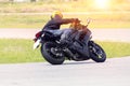 Young man riding motorcycle in asphalt road curve wearing full s Royalty Free Stock Photo