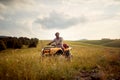 A young man is riding a quad in the nature. Riding, nature, activity