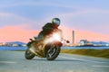 Young man riding sport touring motorcycle on asphalt highways ag Royalty Free Stock Photo