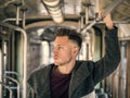 Young man riding on tram or old bus in city