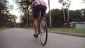 Young man riding a vintage bicycle at the park road. Sporty guy cycling outdoor. Healthy active lifestyle. Low angle of Royalty Free Stock Photo