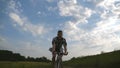 Young man riding vintage bicycle at the rural road over field. Sporty guy cycling along country trail outdoor. Male Royalty Free Stock Photo